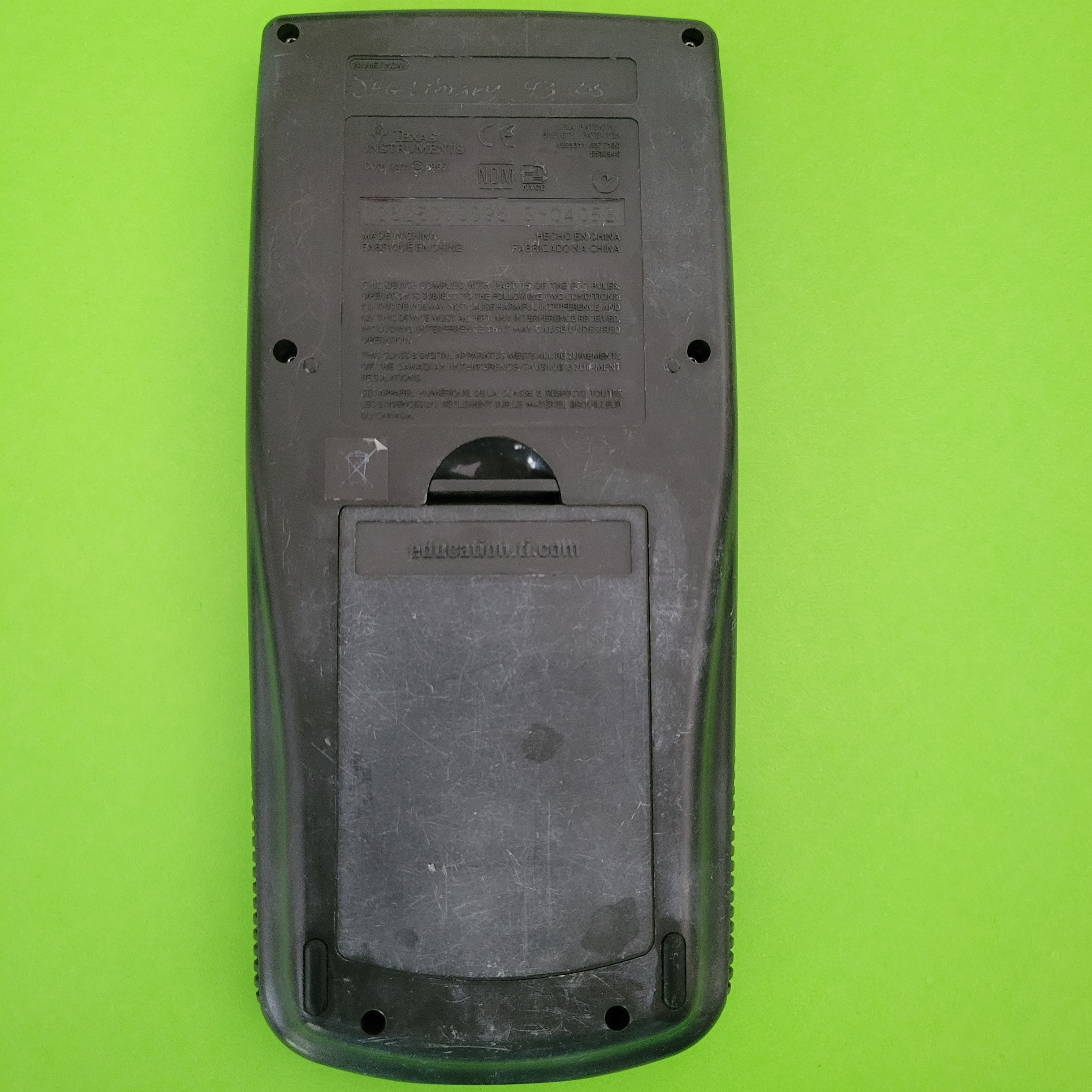 An image of the back of a texas instruments ti83 plus graphing calculator